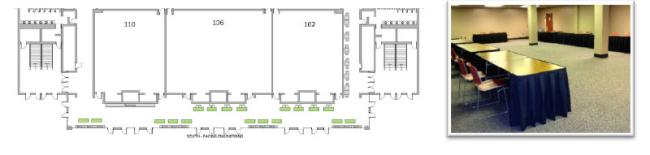 Exhibit layout - large room with tables lining the walls.